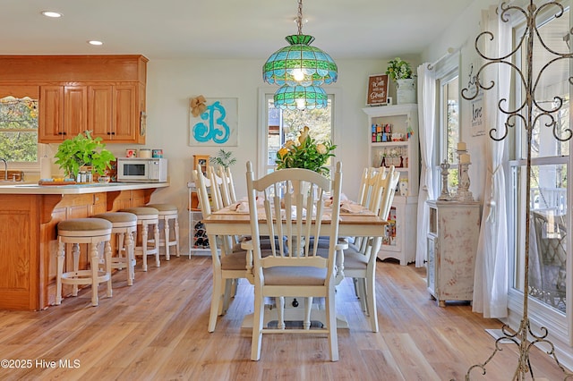 dining room with recessed lighting and light wood-style floors