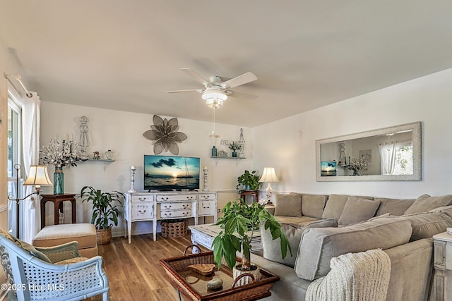 living area with plenty of natural light, wood finished floors, and ceiling fan