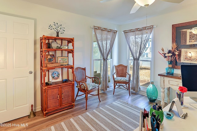 sitting room with wood finished floors and ceiling fan