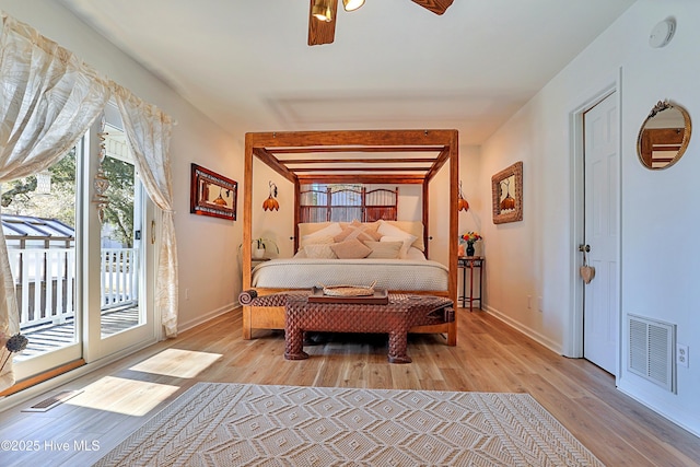 bedroom featuring access to exterior, baseboards, visible vents, and light wood finished floors