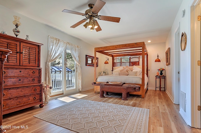 bedroom with light wood-style flooring, multiple windows, baseboards, and access to exterior