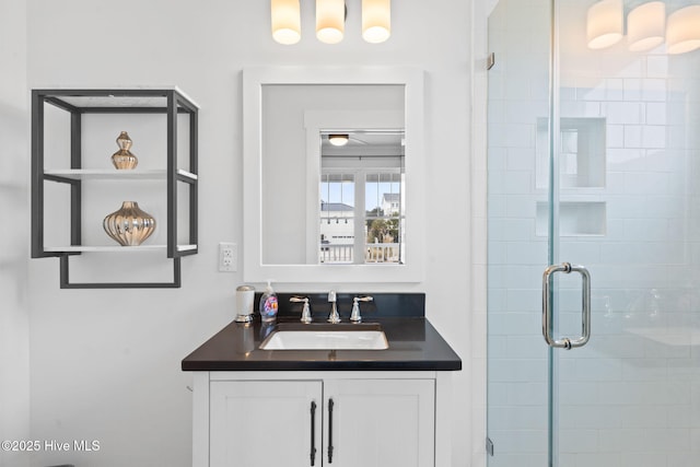 bathroom featuring vanity and a shower with shower door