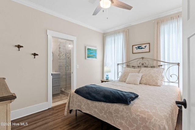 bedroom with connected bathroom, dark wood-type flooring, ornamental molding, and ceiling fan