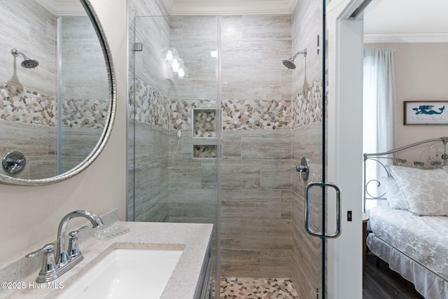 bathroom with ornamental molding, vanity, and walk in shower