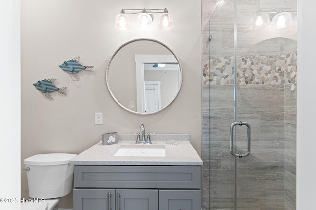 bathroom featuring vanity, toilet, and walk in shower