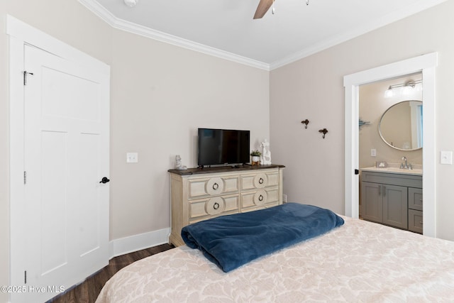 bedroom with connected bathroom, sink, crown molding, and dark hardwood / wood-style floors