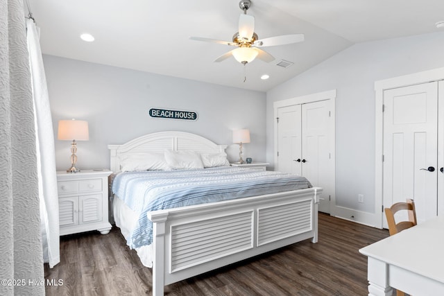 bedroom featuring dark hardwood / wood-style flooring, lofted ceiling, and ceiling fan