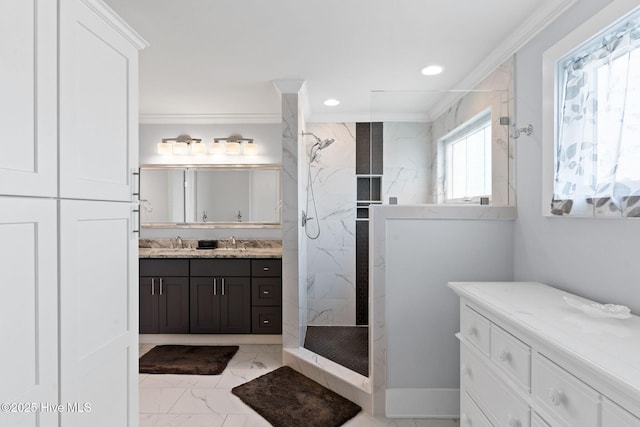 bathroom with crown molding, tiled shower, and vanity