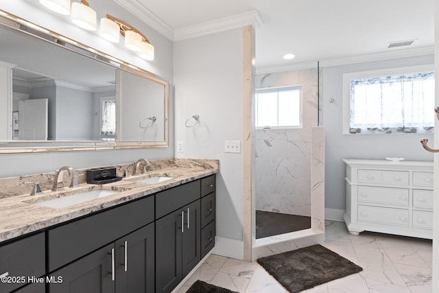 bathroom with ornamental molding, vanity, and a tile shower