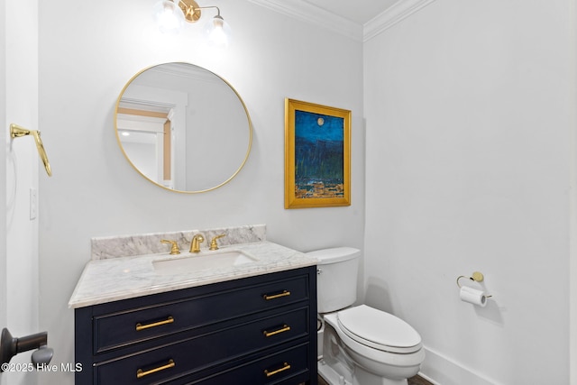 bathroom with vanity, crown molding, and toilet