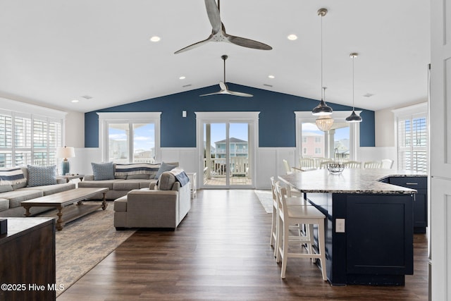 living room with dark wood-type flooring and vaulted ceiling