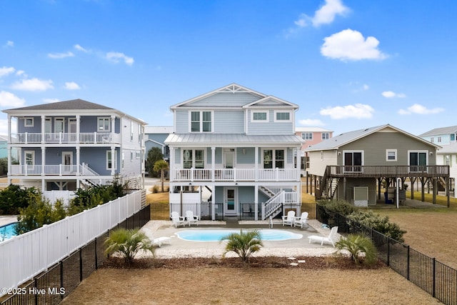 back of house featuring a fenced in pool and a patio area