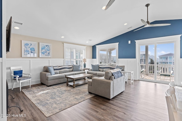 living room with dark hardwood / wood-style flooring, lofted ceiling, and ceiling fan