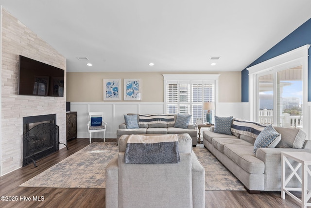 living room featuring a fireplace, lofted ceiling, and dark hardwood / wood-style floors