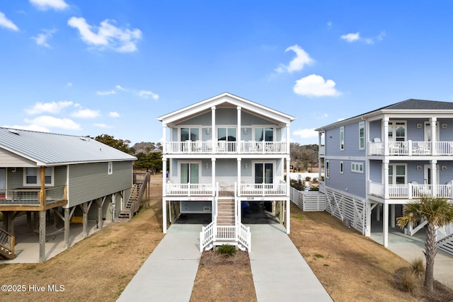 beach home featuring a balcony and a carport