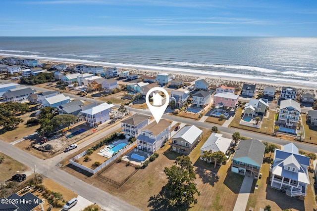 bird's eye view with a water view and a beach view