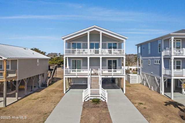 raised beach house featuring a carport and a balcony