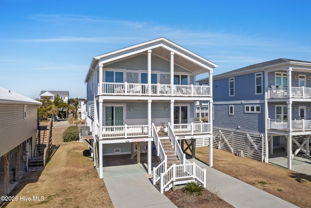 raised beach house with a balcony and a front yard