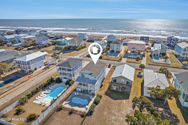 drone / aerial view with a water view and a beach view