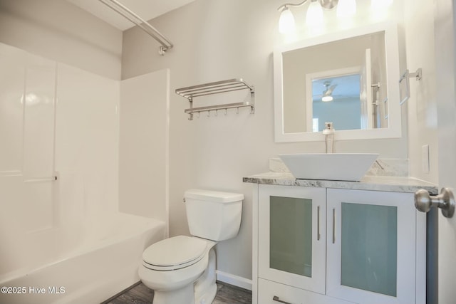 full bathroom featuring vanity, tub / shower combination, hardwood / wood-style floors, and toilet