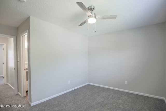 carpeted empty room with ceiling fan and a textured ceiling