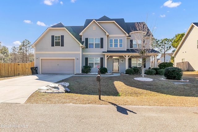 view of property with a garage and covered porch