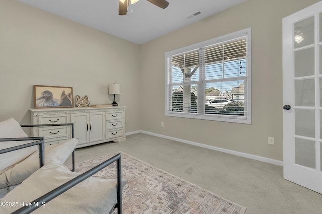 sitting room with light carpet, ceiling fan, and french doors