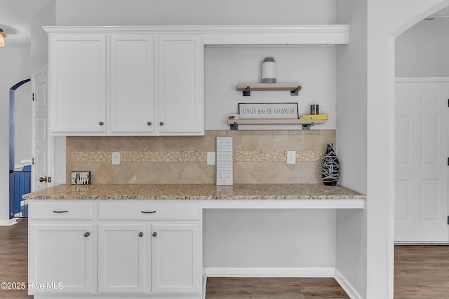 kitchen featuring white cabinetry, light stone counters, tasteful backsplash, and dark hardwood / wood-style floors