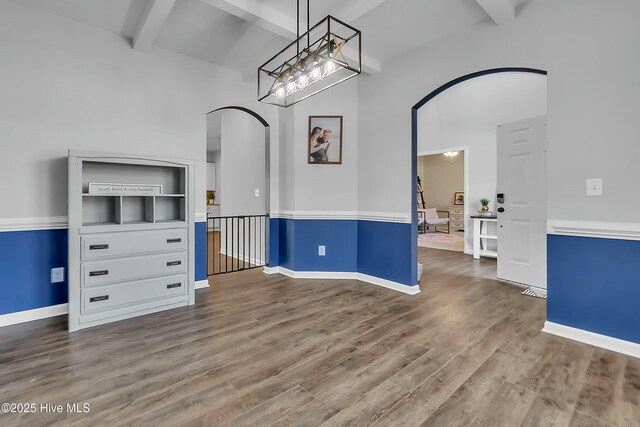 interior space featuring beamed ceiling and wood-type flooring