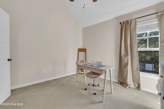 unfurnished office with vaulted ceiling, light colored carpet, and ceiling fan