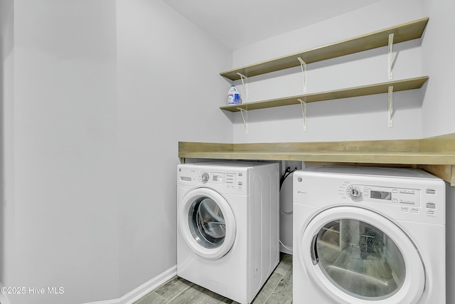 laundry room featuring washer and dryer and light hardwood / wood-style floors