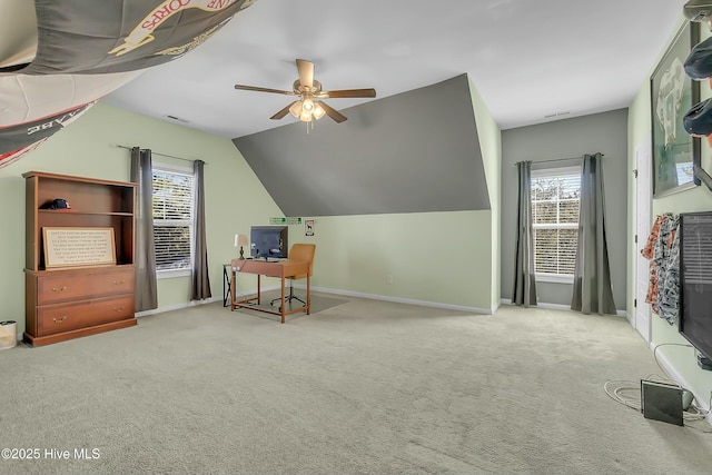 additional living space featuring lofted ceiling, carpet flooring, a wealth of natural light, and ceiling fan