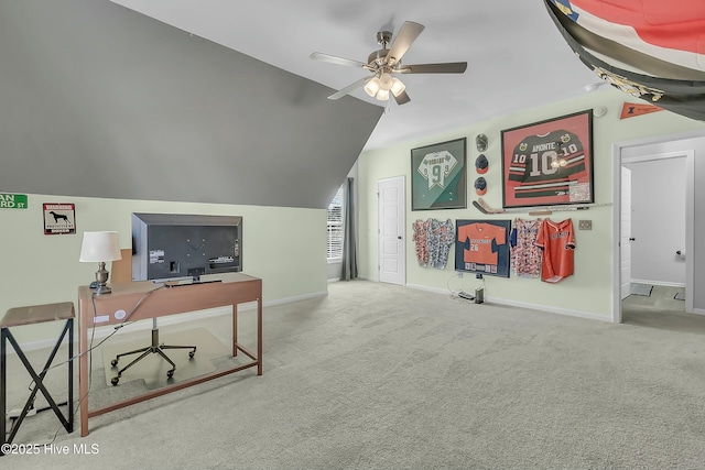 home office with carpet floors, ceiling fan, and vaulted ceiling