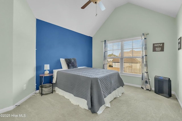 carpeted bedroom with ceiling fan and high vaulted ceiling