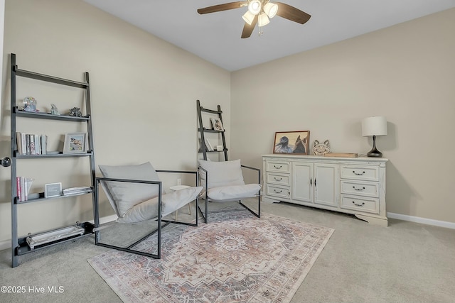 sitting room featuring ceiling fan and light colored carpet