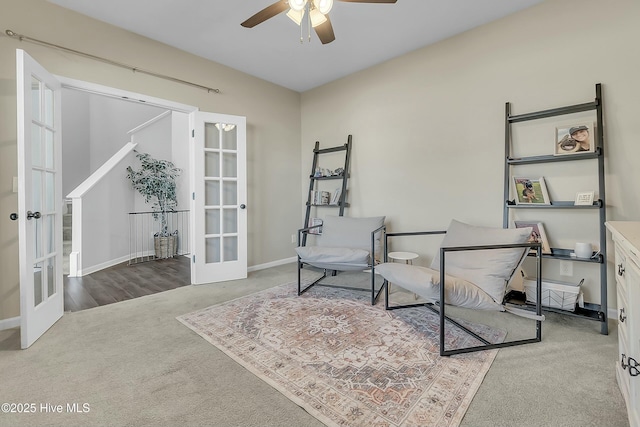 living area with french doors, ceiling fan, and carpet