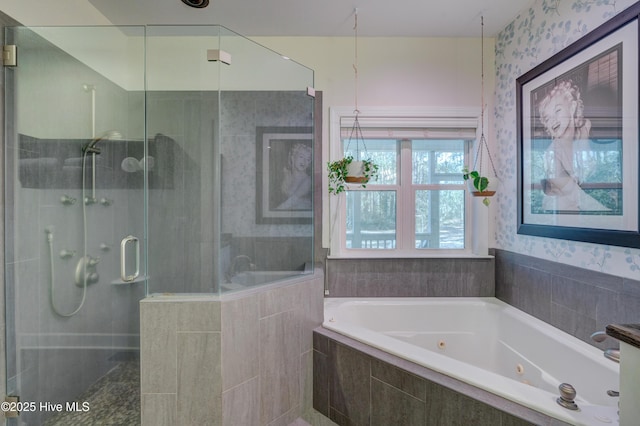 bathroom featuring shower with separate bathtub