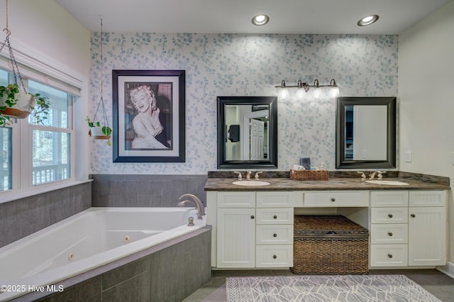 bathroom featuring vanity and a relaxing tiled tub