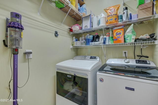 washroom with washing machine and clothes dryer