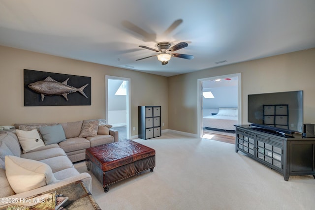 carpeted living room featuring ceiling fan