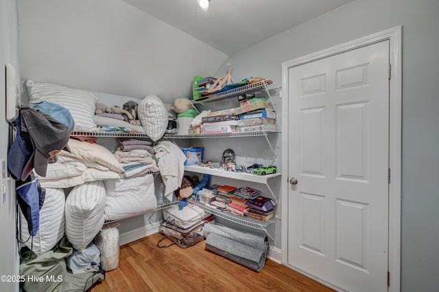 spacious closet featuring lofted ceiling and hardwood / wood-style floors