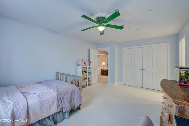 carpeted bedroom featuring a closet and ceiling fan