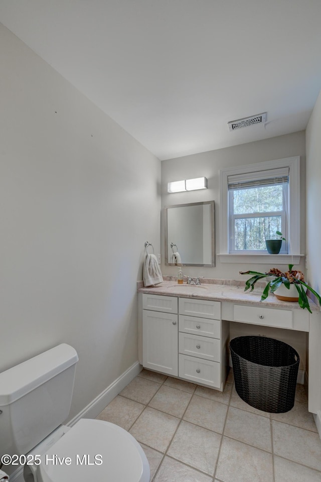 bathroom with tile patterned floors, vanity, and toilet