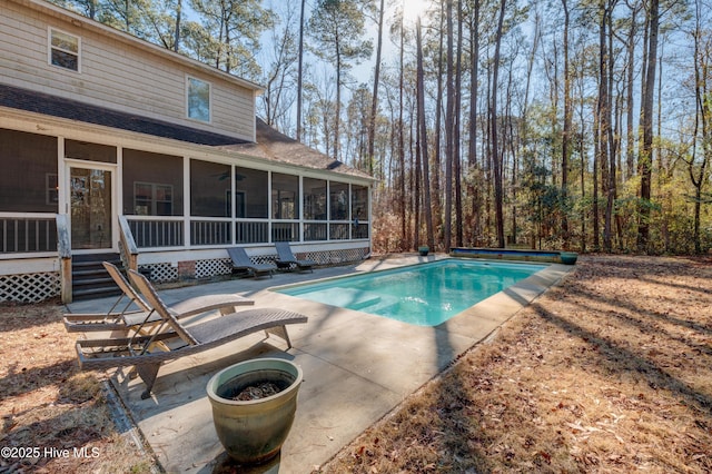 view of pool featuring a patio area and a sunroom