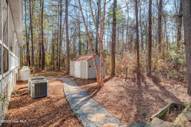 view of yard with cooling unit and a storage shed