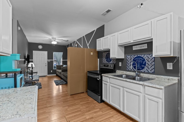 kitchen featuring sink, white cabinets, electric range, ceiling fan, and light hardwood / wood-style flooring