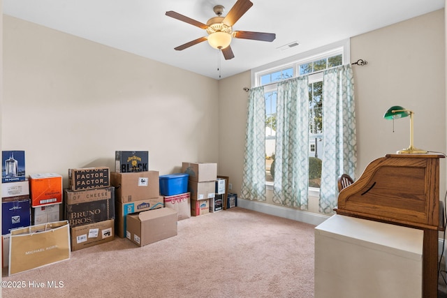 interior space featuring ceiling fan and carpet flooring