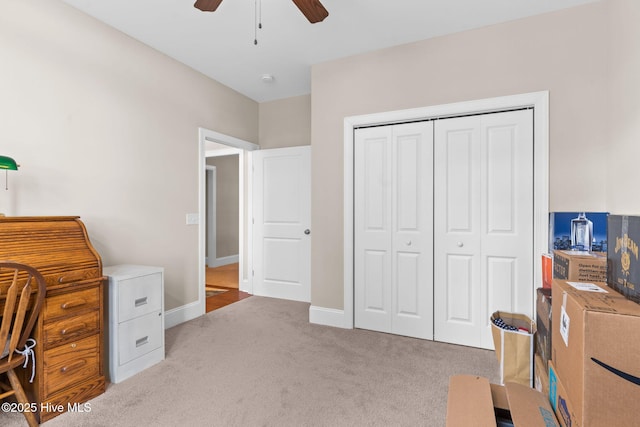 office space with ceiling fan and light carpet