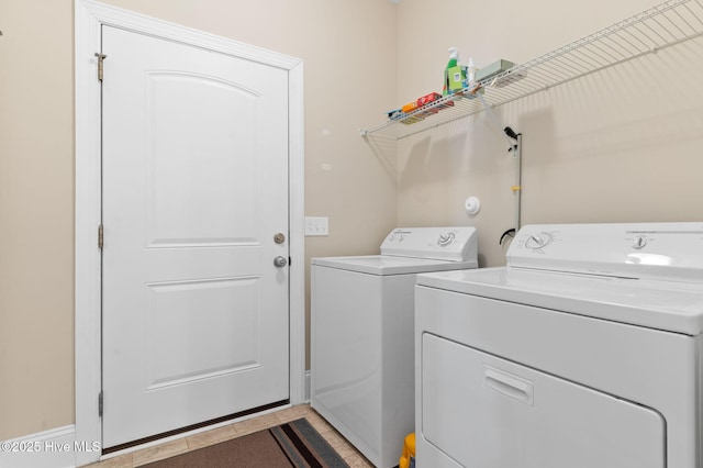 washroom featuring washer and clothes dryer