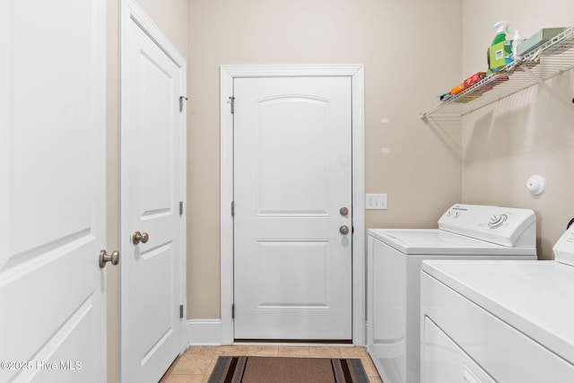 laundry area featuring light tile patterned floors and independent washer and dryer